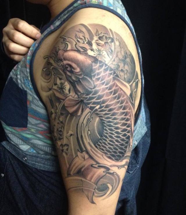 Black & Grey Asian Traditional half sleeve Koi Fish tattoo  Golden Iron Tattoo Studio is located on 363 Spadina Ave Toronto ON, M5T 2G3. For inquires on booking an appointment please contact (416)-903-1624
