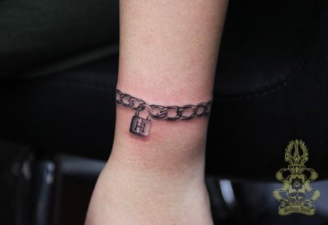 Detailed wrist-let tattoo. 