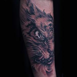Black and grey tiger tattoo by Yunyi For any inquires check us out at http://goldenirontattoostudio.com/ or to book an appointment contact (647) 347-9363 during opening hours 11:00AM-8:00PM